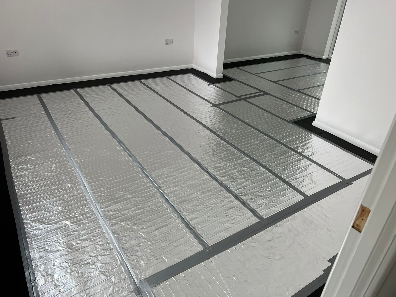 Domestic electric underfloor heating foil mat installation in a London home