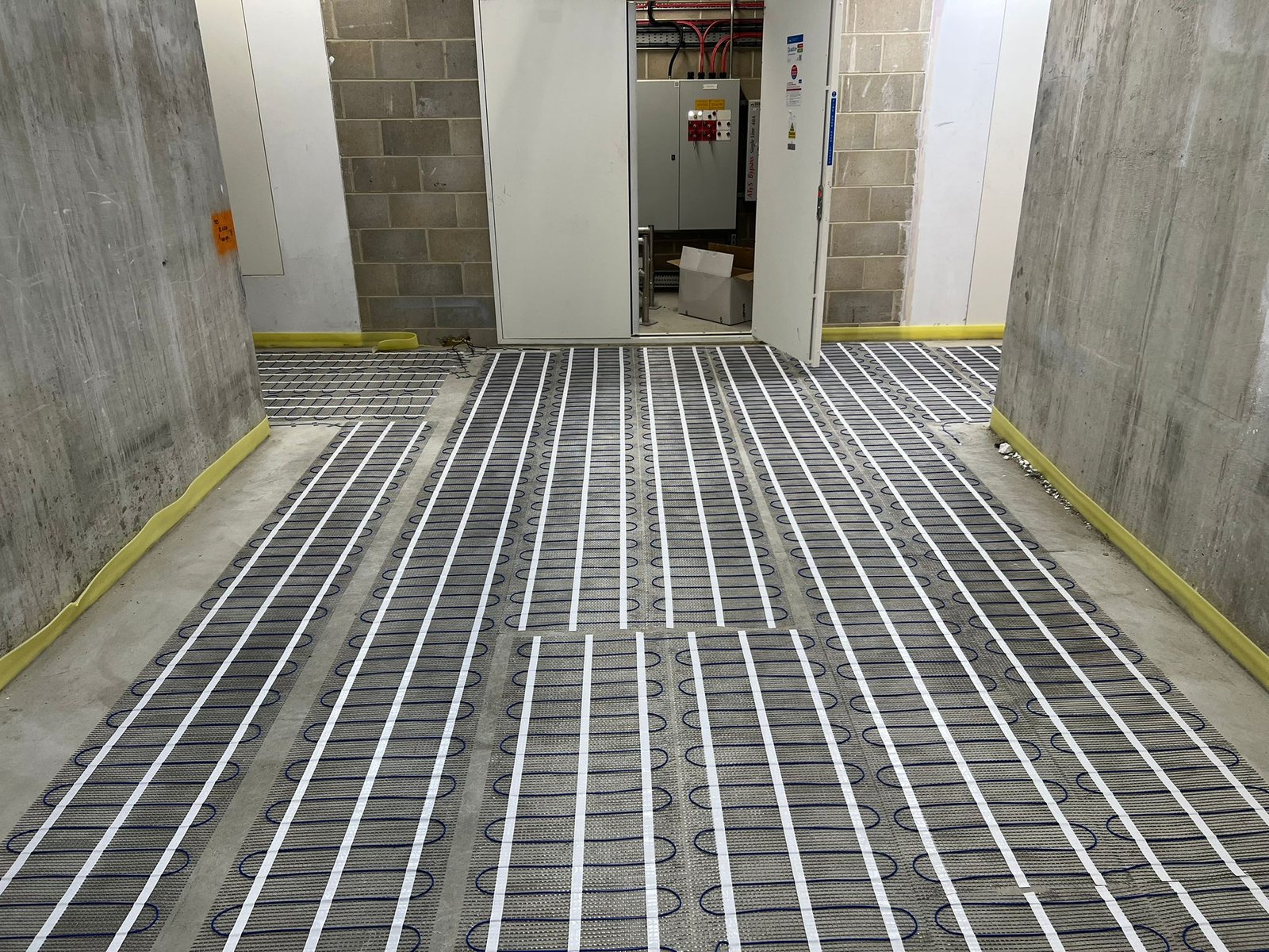 Electric underfloor heating installed in an apartment block communal hall