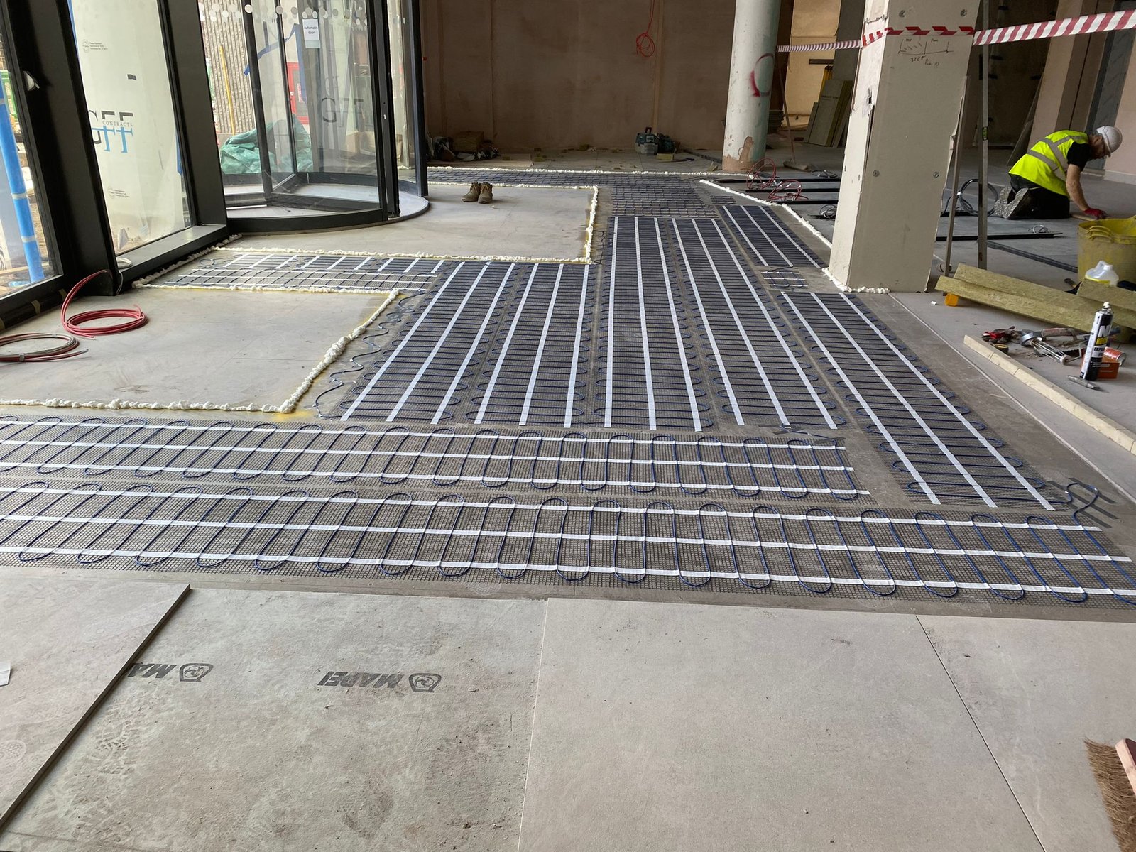 Commercial electric underfloor heating mat installation in a London building