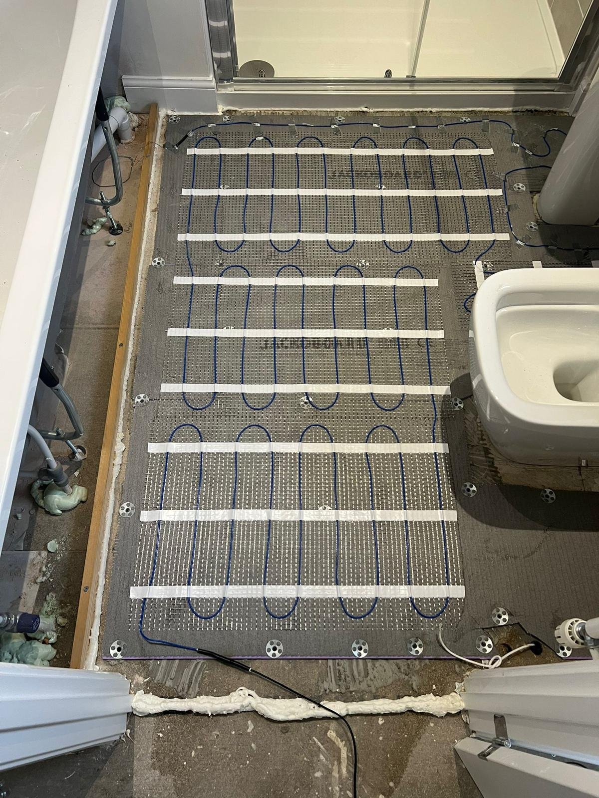 Electric underfloor heating installed in an office block toilet and changing room